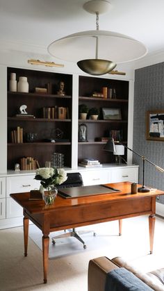 a living room filled with furniture and bookshelves