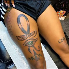 a woman's leg with tattoos on it and an eye in the center is shown