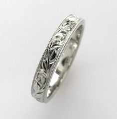 a white gold wedding ring with filigrees and scrolls