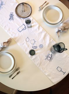 the table is set with dishes and silverware