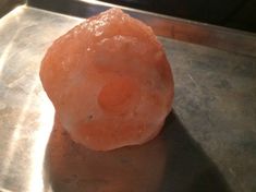 an orange rock sitting on top of a metal tray