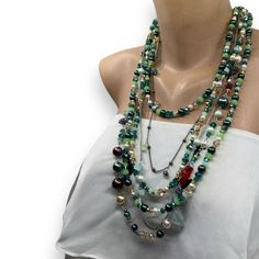 Handmade , Boho Style  Chic, Multi Strand Layered Green and Burgundy Shades Multi Color Necklace Discover this stunning multi-strand bohemian necklace featuring a vibrant mix of pearls, crystals, and semi-precious stones in rich shades of green, gold, and red.  Perfect for making a bold statement, this handmade necklace combines elegance and unique charm with its intricate design.  Whether for casual wear or a special occasion, it adds a touch of boho-chic style to any outfit. Ideal as a gift or Bohemian Beaded Pearl Necklace For Party, Bohemian Beaded Layered Necklace For Party, Bohemian Multi-strand Crystal Necklace With Colorful Beads, Bohemian Double Strand Pearl Necklace With Gemstone Beads, Bohemian Beaded Necklaces With Gemstone Beads For Parties, Bohemian Multi-strand Beaded Crystal Necklace, Bohemian Gemstone Beads Necklace For Parties, Bohemian Gemstone Beaded Necklace For Parties, Bohemian Party Beaded Necklace With Gemstone Beads