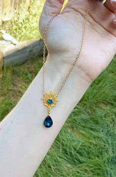 This is one of the beautiful necklaces that Kate wears in season 2. It reminds me of a peacock with the shape and teal blue colors. It is made with a gold tone filigree that has a teal blue rhinestone set into the center. Another teal blue drop rhinestone hangs from the bottom. Choose your preferred length, as shown it is 16 inches. This lovely piece makes a great gift for a loved one or yourself. Blue Brass Jewelry For Wedding, Ornate Peacock Design Necklace For Gift, Handmade Peacock Colored Jewelry For Weddings, Handmade Peacock Wedding Jewelry, Elegant Blue Peacock Design Jewelry, Elegant Peacock Pendant Necklace, Elegant Peacock Color Pendant Necklace, Elegant Blue Brass Necklace, Blue Filigree Necklace For Wedding