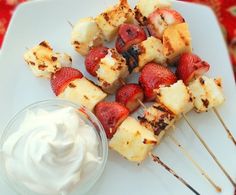 strawberries and bananas on skewers with whipped cream