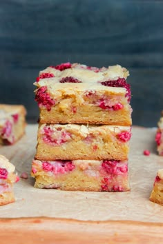 raspberry cheesecake bars stacked on top of each other