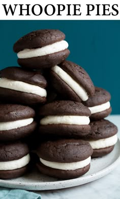 a stack of chocolate cookies with white frosting