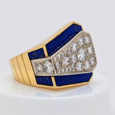 Add a touch of elegance to your jewelry collection with this stunning 18K yellow gold Diamond and Lapis Lazuli Ring. This ring contains thirty (30) Round Diamonds totaling approx. 1.50 carats combined total carat weight. These Diamonds are Graded approx. G/H Color, VS1/VS2/SI1 Clarity. The Lapis Lazuli inlayed in this ring is very high quality. 18K Metal weight (with stones) is approx. 21.77 grams The combination of stones make it a perfect addition to any vintage or antique jewelry collection. Exquisite Yellow Gold Multi-stone Diamond Ring, Exquisite Gold Multi-stone Diamond Ring, Luxury Yellow Diamond Ring Hallmarked, Luxury Yellow Diamond Hallmarked Ring, Luxury Yellow Gold Sapphire Ring For Anniversary, Elegant Blue Diamond Signet Ring, Luxury 14k Gold Sapphire Ring Hallmarked, Luxury 14k Stamped Sapphire Ring, Luxury 14k Gold Sapphire Ring With Hallmark