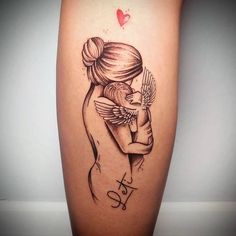 a woman's leg with a tattoo on it and an angel hugging her arm