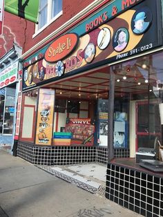 a store front with many signs on the side of it's windows and doors