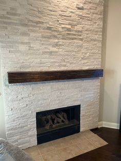 a living room with a white brick fireplace