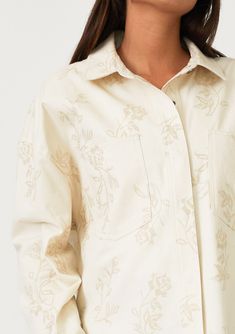 An embroidered cotton shirt jacket with a snap button front. Embroidered Relaxed fit Long sleeves Button wrist closure Collared neckline Snap button front Front patch pockets Lightweight shirt jacket Delicate embroidered floral details add a bohemian touch to this cool, lightweight spring shirt jacket. With long sleeves, a classic collared neckline, and a snap button front. The perfectly relaxed fit layers well over a simple tee or a light sweater. Model is 5'9, wearing a size S.Style: I-20289W- Fall Long Sleeve Outerwear With Tonal Embroidery, Floral Embroidered Shirt For Workwear In Fall, Spring Cotton Blouse With Snap Buttons, Fall Outerwear With Tonal Embroidery Long Sleeve, Button-up Blouse With Floral Embroidery For Work, Floral Embroidery Button-up Work Tops, Spring Cotton Shacket With Spread Collar, Spring Beige Shirt With Floral Embroidery, Floral Embroidery Button-up Top For Work