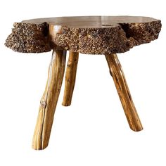 a table made out of wood with two logs on the top and one log at the bottom