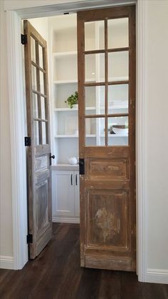 an open wooden door in a white room