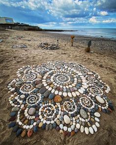 a circle made out of rocks on the beach