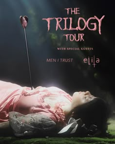 a woman laying on the ground with a stick in her hand and text that reads, the trilogy tour