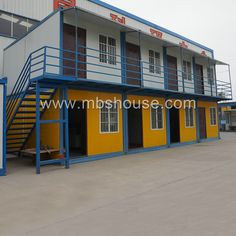 an empty building with stairs leading up to it