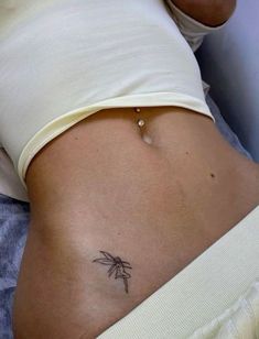 a woman with a small tattoo on her stomach