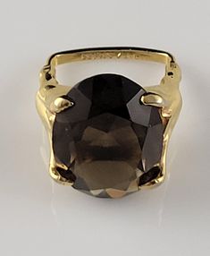 *Size 5 *Weighs-6.5 grams *The topaz tests as genuine. *1960s genuine, Smokey Topaz Statement Ring by Vendome The stone is set in a goldtone setting that wears beautifully. *Vendome was part of the Coro Jewelry company.  *Stamped-PAT number 2 961855  for the unique adjustable ring design. You simply pull or push the squared off back of the ring to adjust the size. This mechanism is a little sticky, so it may be best to leave it at a size 5. *Striking Oval cut Smokey Topaz in a classic & unique setting. This ring makes a dramatic statement on the hand. *Dates from the 1940s-1950s. This ring is almost 90 years old! *Condition-In near mint estate condition. It's in exceptional shape for its age. Minimal signs of wear & patina. This ring seems barely worn & extremely well cared for. *Highly co Coro Jewelry, Smokey Topaz, Jewelry Companies, Number 2, Adjustable Ring, Adjustable Rings, Statement Ring, Rings Statement, Oval Cut