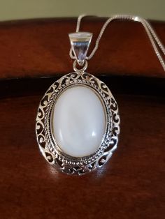 "Beautiful natural MOTHER-OF-PEARL necklace. The 18x14mm oval white Mother of Pearl is surrounded by an intricate, layered bezel setting. It almost looks like a cake from the side🤭 The large bale is hinged, and will certainly accommodate other chains too. Pendant measures 1.5\" long including the bale, and 22mm across. All Sterling Silver, weighs 9.3 grams 18\" Sterling Silver box chain Hallmarked 925 THAILAND (with maker's mark) Brand New Contact me with any questions" White Sterling Silver Oval Link Jewelry, White Sterling Silver Jewelry With Oval Link, Classic Oval Handmade Necklaces, White Oval Link Necklace For Anniversary, White Necklace With Intricate Round Design, White Round Necklace With Intricate Design, White Round Necklaces With Intricate Design, White Oval Necklace With Intricate Design, Classic White Oval Pendant Jewelry