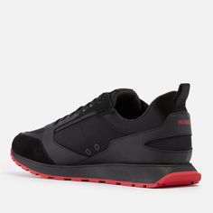 a black sneaker with red soles