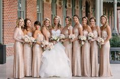 a group of women standing next to each other in front of a red brick building