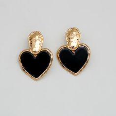 Discover Timeless Elegance Introducing our latest collection piece, the Black Heart Drop Earrings, a perfect blend of vintage charm and contemporary fashion. These earrings feature a classic heart shape, embodying love and elegance in every detail. Crafted from durable zinc alloy, they boast a glossy black finish that adds a touch of sophistication to any outfit. Ideal for women who adore fashion-forward accessories, these earrings are sure to make a statement at any event. Product Features Our