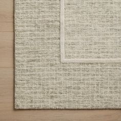 an area rug with a white border on top of it