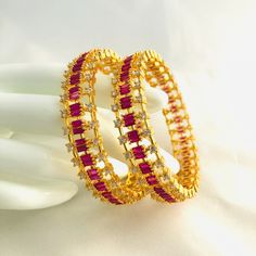 2.8,2.6 size CZ Bangles/Sabyasachi Bangles/Cubic Zirconia Ruby Bangles/Indian Bridal Jadau Bangles/CZ Bangles/Punjabi Wedding Bangles/Bollywood Features Traditional Cubic Zirconia and Pink stones bangles Set Handcrafted To Perfection Light Weight Perfect For Indian Weddings And Celebrations A Beautiful & Memorable Gift for Weddings and Special Occasions Available in 2.6,2.8 size The base metal color is Gold tone brass studded with colorful semi-precious stones on it. Pair of 2 bangles For mo Festive Ruby Bangle For Wedding, Party Jewelry Bangle With Zari Work, Festive Cubic Zirconia Bangle For Wedding, Festive Wedding Cubic Zirconia Bangle, Bollywood Bridal Sets With American Diamond, Festive Traditional Bangle With American Diamond, Traditional American Diamond Bangle For Festive Occasions, Festive Cubic Zirconia Wedding Bangle, Ruby Bangle For Wedding