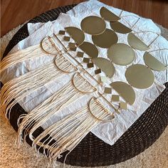 a table topped with lots of metal discs and tassels