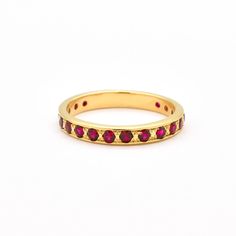 Gold Ruby Ring set with Created Ruby in a flawless diamond cut & stunning red color, at size 2mm each (2 Cts combined).Gold Vermeil: 18k Gold over Solid 925 Sterling Silver ☞ made to last.Matching Pendant - please ask meMatching Earrings- please ask me Details:• Created Ruby in a flawless clarity• Ruby: 2mm each, 1 Ct combined, diamond cut• Dimensions: Band width ≈ 3mm, thickness ≈ 2mm• Solid 925 Sterling SilverSKU 2430 Luxury Ruby Jewelry Channel Set, Ruby Round Eternity Band Fine Jewelry, Luxury Ruby Channel Set Jewelry, Luxury Channel Set Ruby Jewelry, Fine Jewelry Ruby Eternity Band Round Cut, Ruby Round Cut Eternity Band, Gift Ruby Ring With Channel Set Diamonds, Elegant Red Promise Stackable Rings, Elegant Red Ruby Eternity Band