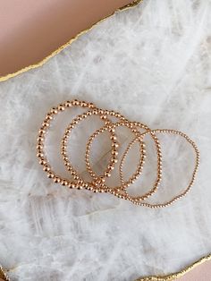 14k rose gold filled beaded stretch bracelet. Please measure your wrist and select your size in the dropdown as this bracelet is not one size fits all. SIZING TIP: To find out your bracelet size, wrap a piece of string around your wrist to measure (place it just above the wrist bone.) Then measure the length of the string. Then I'd recommend adding 0.8 inches (2cm) to that measurement to get your correct bracelet size. Rose Gold Stackable Stretch Bracelet With Round Beads, Rose Gold Stackable Bracelet With Round Beads, Dainty Hand-strung Rose Gold Bracelet, Elegant Rose Gold Beaded Bracelets With Tiny Beads, Rose Gold Dainty Jewelry With Gold Beads, Dainty Rose Gold Jewelry With Gold Beads, Stackable Round Beads Bracelets In Rose Gold, Stackable Rose Gold Bracelets In 14k Gold Filled, Hand-strung Rose Gold Beaded Bracelets For Everyday