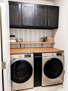 a washer and dryer in a small room with cabinets above the washer