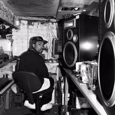 a man sitting in a kitchen next to a washer and dryer