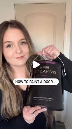 a woman holding up a paint bucket with the words how to paint a door on it