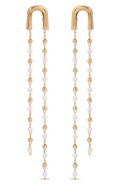 Accessorize in dainty yet dramatic style with these 18-karat gold-plated earrings dotted with lustrous imitation pearls. 2 3/4" drop Post back 18k-gold plate/acrylic imitation pearl Imported Gold Linear Earrings With Pearl Chain For Party, Elegant Gold Beaded Chain Chandelier Earrings, Elegant Gold Chandelier Earrings With Beaded Chain, Gold Pearl Chain Chandelier Drop Earrings, Gold Chandelier Drop Earrings With Pearl Chain, Gold Chandelier Earrings With Pearl Chain, Elegant Beaded Chandelier Earrings, Dramatic Style, Halle Berry