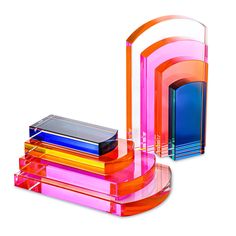 an assortment of colorful glass items are stacked on top of each other in different colors