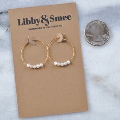 "You asked for it -- a tiny version of our semi-precious hoops. Available in a choice of energy-lifting gemstones, it's no wonder they've become a Libby & Smee favorite. Bonus: Moonstone is said to increase feminine energy, fertility, and sensuality! Your inner goddess will thank you. + 25mm (about 1\") gold-plated or silver-plated hoops with 3mm Moonstone beads + packaged on a hand-stamped kraft earring card in a clear resealing bag making them ready for gift giving. Additional gift wrap is ava Increase Feminine Energy, Tiny Gold Hoop Earrings, Earrings Small Hoop, Gemstone Hoop Earrings, Hoop Earrings Silver, Earring Card, Long Tassel Earrings, Small Hoop Earrings, Tassel Jewelry