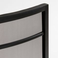 a close up view of the back of a black metal headboard with mesh panels