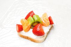 a piece of bread topped with fruit on top of it