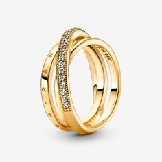 Go for linear layers with the Crossover Pavé Triple Band Ring. Hand-finished in 14k gold plating, this ring features three bands, with one diagonally overlapping the other two. One inner band is embossed with the Pandora logo, the other inner band is polished and the outer band features clear cubic zirconia pavé framed by micro-beading. Inspired by the mesmerising structure of the solar system, this ring brings sleek, structural sophistication to any look. Pandora Crossover Pavé Triple Band Ring Silver Wedding Gifts, Pandora Logo, Triple Band Ring, Jewelry Accessories Ideas, Pandora Rings, Rings Jewelry Fashion, Pave Ring, Thomas Sabo, Gold Plated Rings