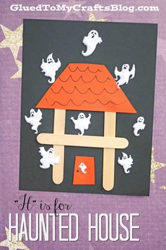 a house made out of popsicle sticks with ghost decorations on it and the words happy halloween written in white