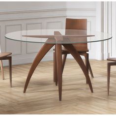 a glass table with wooden chairs around it