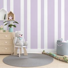 a teddy bear sitting on a chair in a child's room with striped walls