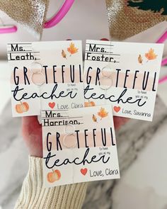 two hand holding some cards that say grateful and i love you teacher with fall leaves on them