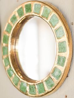 a round mirror mounted to the side of a wall