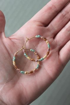 "Seed beads woven with wire onto a brass hoop making a circle of tiny, delicate flowers. This hoop measures 1.25\" in diameter.  **Please note that colors may vary slightly due to difference in monitor and phone screens**" Summer Hoop Earrings With Tiny Beads, Bohemian Hoop Earrings As Spring Gift, Bohemian Hoop Earrings For Spring Gift, Handmade Bohemian Hoop Earrings For Spring, Bohemian Handmade Hoop Earrings For Spring, Handmade Bohemian Jewelry For Spring, Bohemian Spring Jewelry With Colorful Beads, Spring Bohemian Jewelry With Colorful Beads, Summer Hoop Jewelry With Tiny Beads