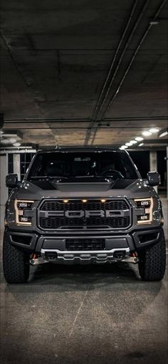 a truck parked in a parking garage with lights on it's front bumpers