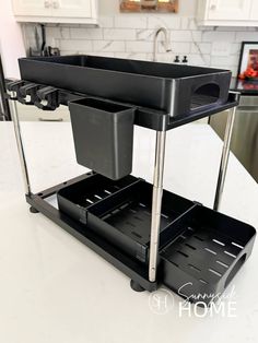 Bathroom organizer on the countertop with two sliding trays, hooks.