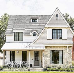 a white house with black shutters and windows