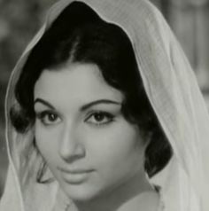 an old photo of a woman wearing a veil